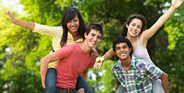 Happy teenagers standing outside.